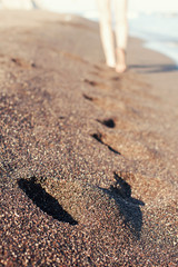 Footprints in the black sand
