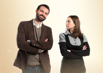 Couple with their arms crossed over isolated background