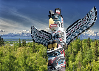 Totem wood pole in mountain background