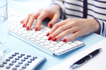 Woman with hands on computer keyboard