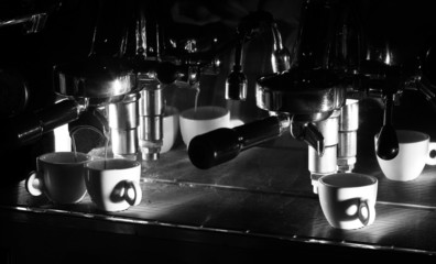Espresso machine brewing a coffee. Black and white photo