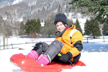Fototapeta na wymiar child in the winter plays with bob