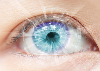Close-up of woman's blue eye. High Technologies in the futuristi