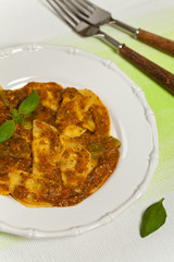 Spinach stuffed ravioli with tomato sauce and parmesan cheese