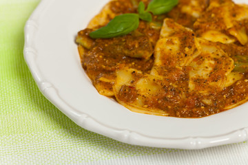 Spinach stuffed ravioli with tomato sauce and parmesan cheese