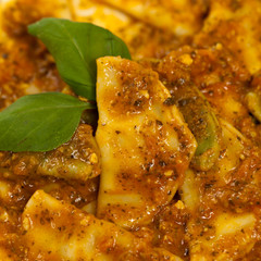 Spinach stuffed ravioli with tomato sauce and parmesan cheese
