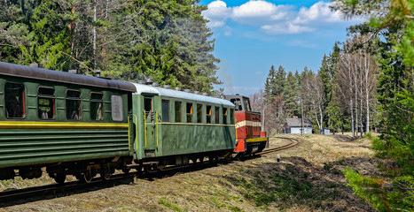 Fototapeta premium Passenger train on old narrow-gauge railway.
