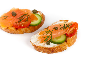 Finger food canape with smoked salmon on white background