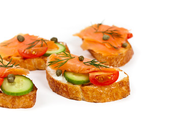 Finger food canape with smoked salmon on white background