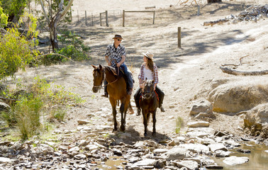 father horse instructor of  teen daughter riding little pony 