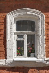 Old window with red brick wall