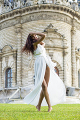 Portrait of young woman in long white dress