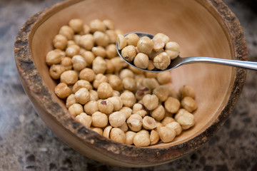 closeup of hazelnuts in wooden bowl