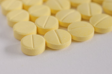 Fototapeta na wymiar Heap of yellow round medicine tablet