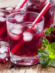 Fresh red juice cocktail with pomegranate seeds, mint and ice, s