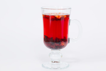 Red flowers fruit tea isolated in the transparent glass