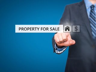 Businessman pressing property for sale button