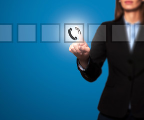 Businesswoman hand press telephone icon button on visual screen