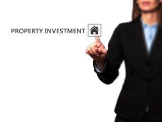Businesswoman pressing Property Investment button