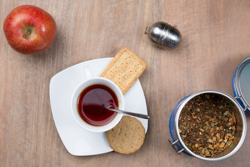 A morning breakfast with cake, apple and hot tea