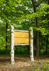Wooden sign board in the woods