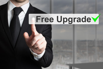 businessman pushing button free upgrade