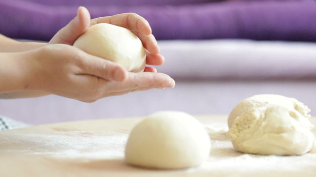 Women's hands expertly molded from soft dough pies