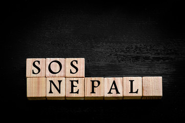 Message SOS NEPAL isolated on black background