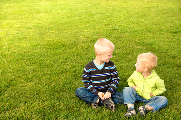 Naklejka na ściany i meble Happy children on green grass
