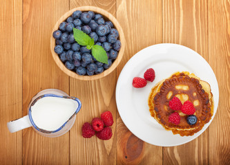 Pancakes with raspberry, blueberry and milk