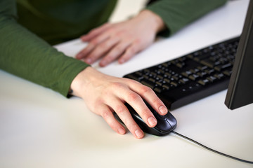 close up of male hands holding computer mouse