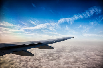 Wing of the plane on blue sky background