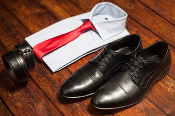 shirt, shoes and belt on a wooden background