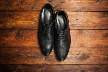 leather men's shoes on a wooden background