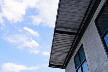 Fototapeta na wymiar roof of sheet metal and blue sky