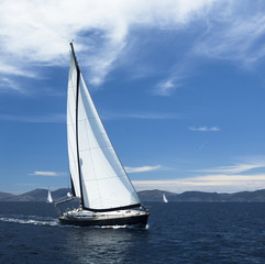 Sailing. Yacht sails with beautiful cloudless sky. Luxury yacht.