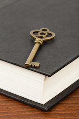 Antique key on book cover