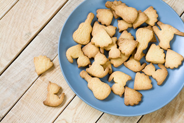 Grey plate with tasty cookies in the form of figurines of cats