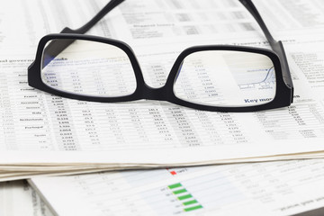 Glasses on business newspapers