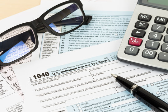 Tax form with glasses, and calculator