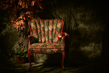Antique Empty Chair with Colorful Pattern and Plant.