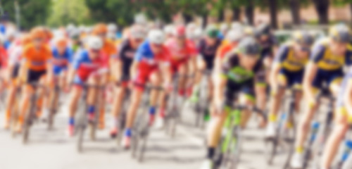 Bikers during bike race on city street, defocussing effect 