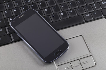 Mobile phone on laptop keyboard