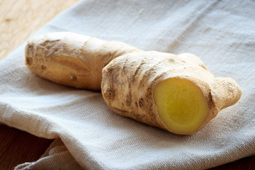 Closeup fresh raw ginger on rustic table