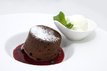 Chocolate desserts and ice cream on a plate decorated with mint
