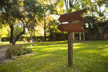 wooden garden sign pointing down the path
