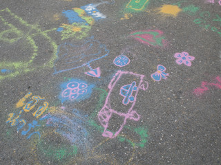 Colored chalks. Colored chalk on playground with drawings on str