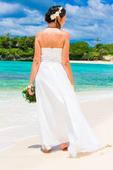 Fototapeta na wymiar beautiful fiancee in white wedding dress with big long white tra