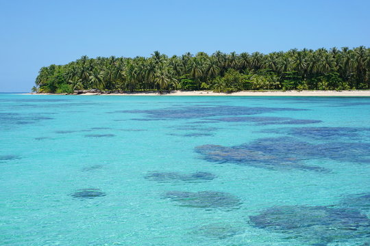 Turquoise water with corals and tropical island