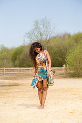 young indian woman walking along the river bank